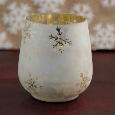 White glass tea light holder with snowflakes.
