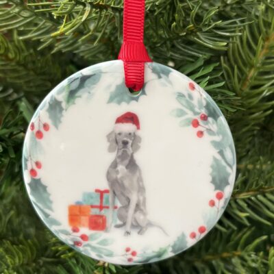 Hanging decoration of a Weimaraner wearing a Christmas hat