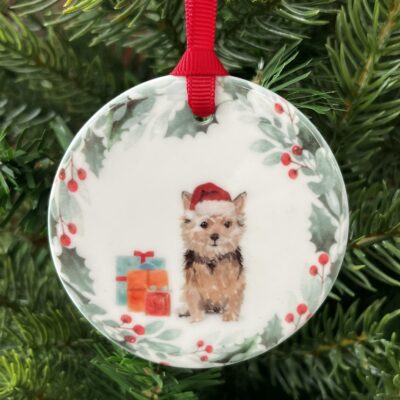 Hanging decoration of a Norfolk Terrier wearing a Christmas hat