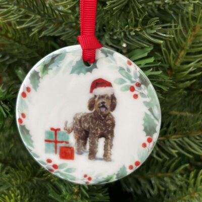 Hanging decoration of a Brown Labradoodle wearing a Christmas hat