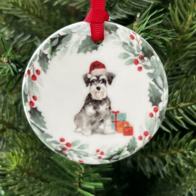 Hanging decoration of a Schnauzer sitting down wearing a Christmas hat