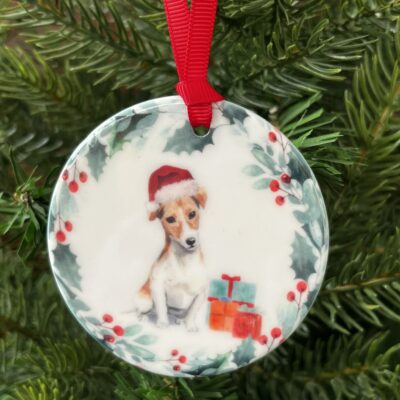 Ceramic hanging decoration. An image of a short haired Jack Russell wearing a Christmas hat