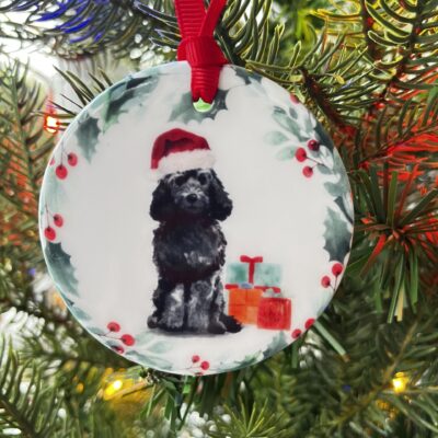 Hanging decoration with an image of a Black Cockapoo wearing a Christmas hat