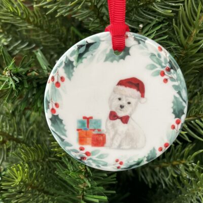 Hanging decoration of a West Highland Terrier wearing a Red bow tie and a Christmas hat