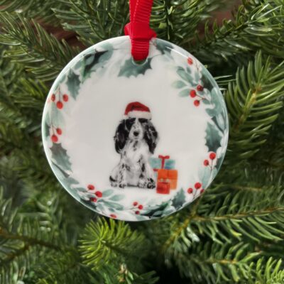 Ceramic hanging decoration with a watercolour image of a Black and White Cocker Spaniel on it.