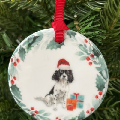 Ceramic hanging decoration with a watercolour image of a Black and White Springer Spaniel on it.