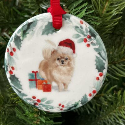Hanging decoration of a Pomeranian wearing a Christmas hat