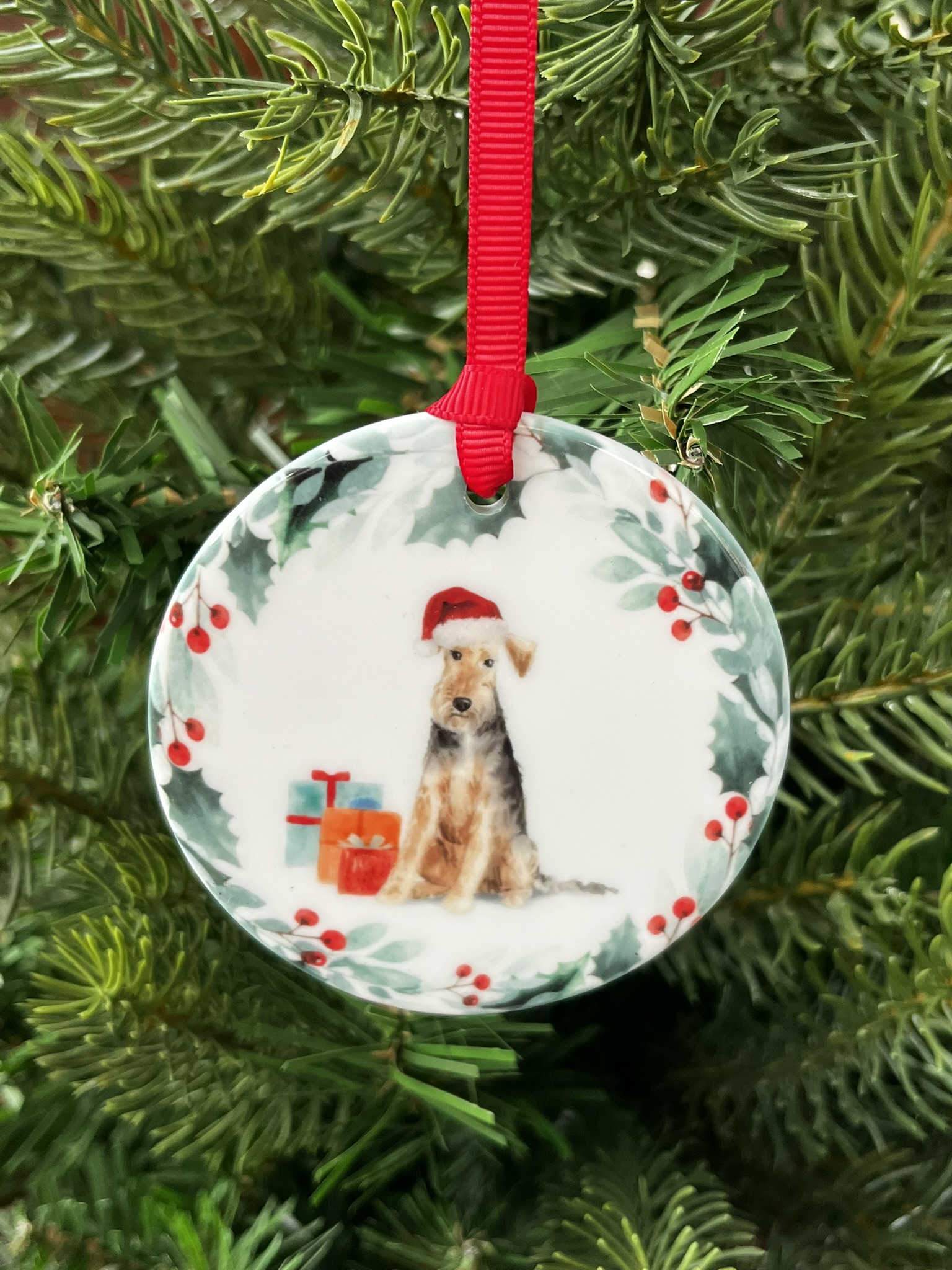 Ceramic hanging decoration with an image of a Welsh Terrier printed on it