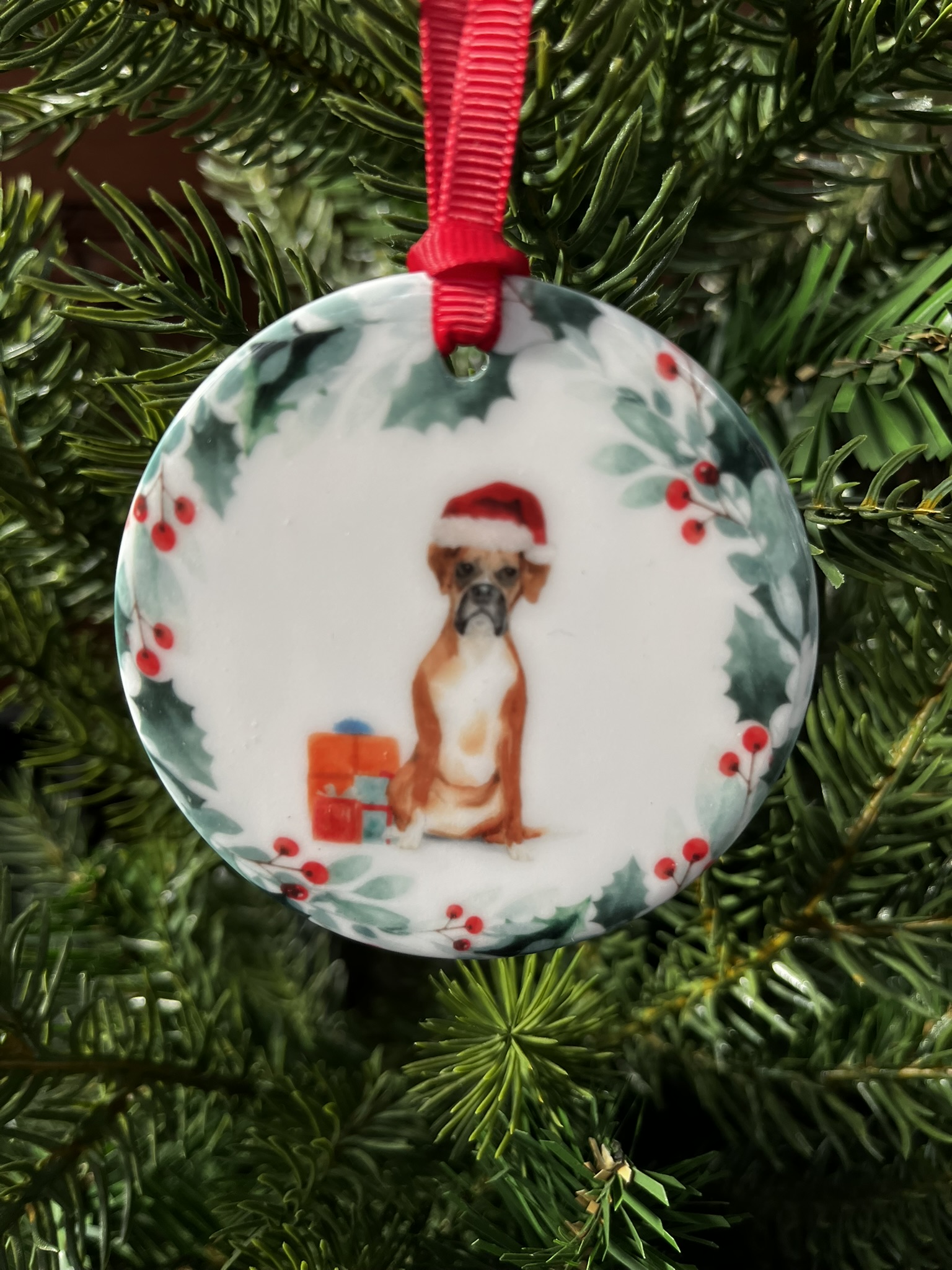 Hanging decoration with an image of a Boxer dog wearing a Christmas hat